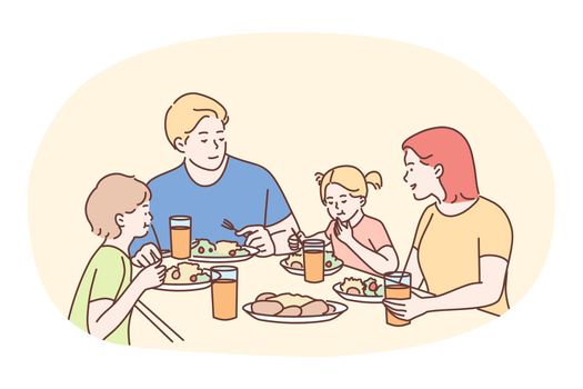 Happy family having dinner or breakfast together at home