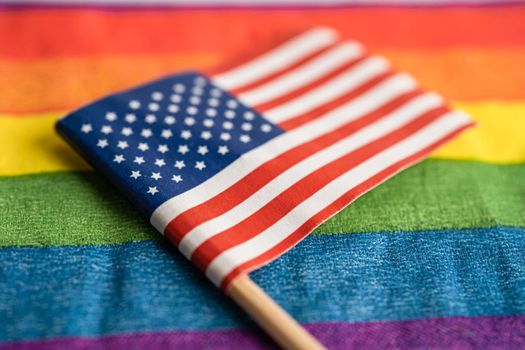 USA America flag on rainbow background symbol of LGBT gay pride month  social movement rainbow flag is a symbol of lesbian, gay, bisexual, transgender, human rights, tolerance and peace.