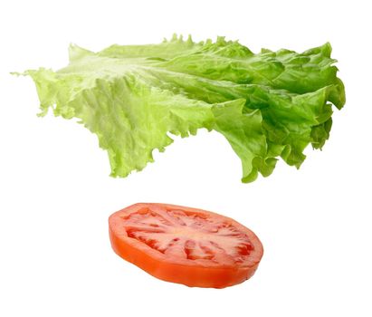 Green lettuce and round slice of ripe red tomato isolated on white background, close up