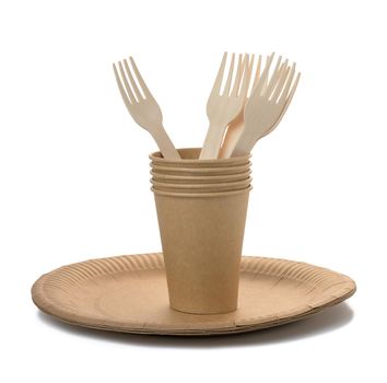 Brown paper cups, wooden fork and plates on a white background. Recyclable garbage, rejection of plastic
