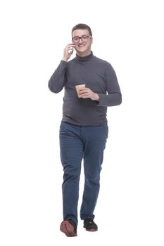 casual young man with smartphone and takeaway coffee.