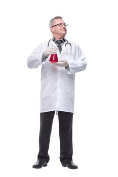Doctor holding up beaker of red chemical in the laboratory