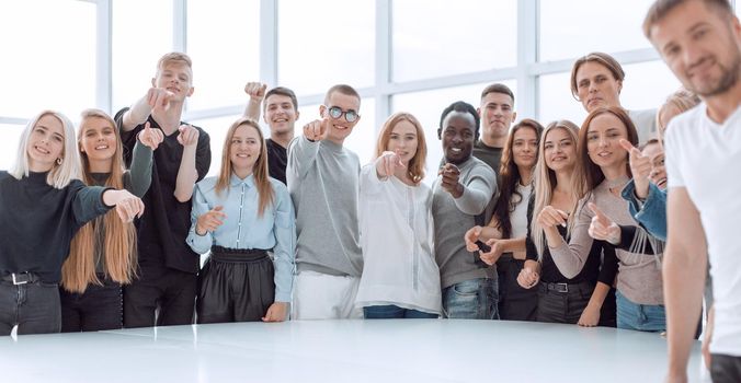 multinational group of young people pointing at you