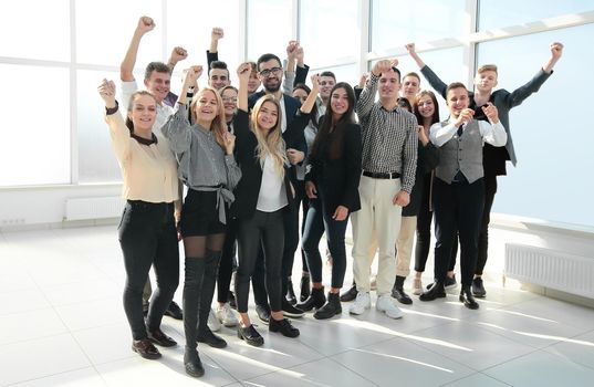 group of ambitious young people standing in a new office