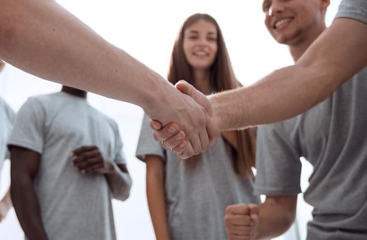 handshake of young people in a circle of friends