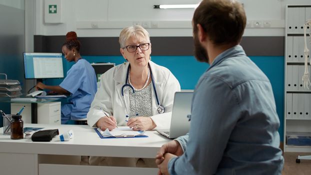 Physician and man having conversation about health care at appointment