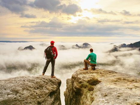 Two friends, hiker thinking and photo enthusiast takes photos of fall 