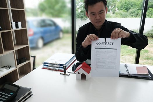 businessman tearing agreement document. breaking contract