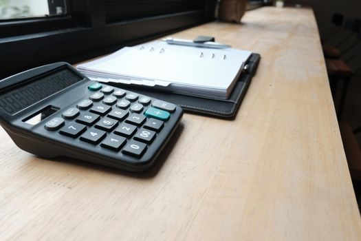 calculator & notebook on accountant desk. bookeeper, financial inspector workplace