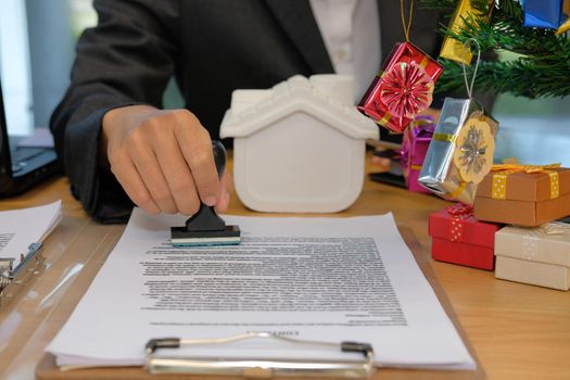 real estate agent stamping approved on mortgage loan contract agreement document during christmas