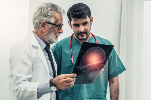 Doctor at hospital working on x ray film image.