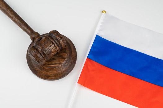 Russian federation flag and judge's gavel on a white table.