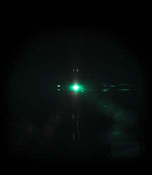 Cyan light Lens flare on black background.