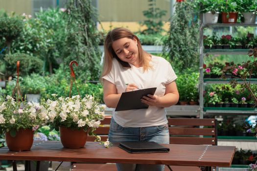 Portrait of garden center manager working with flowers