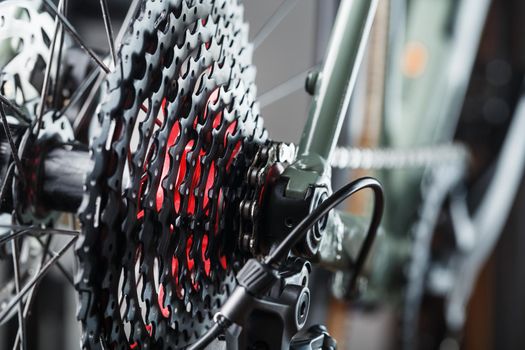 Black bicycle 11-speed cassette with switch and chain close-up, accessories for bike repair and tuning