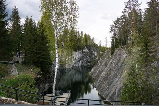 Marble quarry with the lake in Ruskeala park on a spring day. Karelia landscape