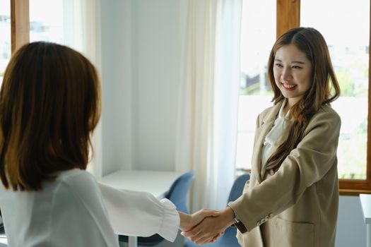 Young businesswoman collaborate with partners to increase their business investment network for Plans to improve quality next month in their office. agreement concept.