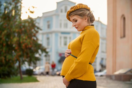pregnant woman in yellow sweater