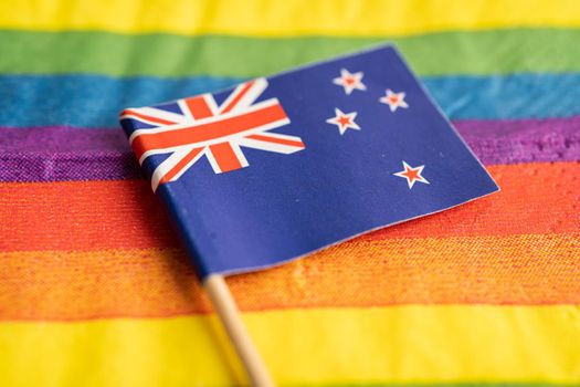 New Zealand flag on rainbow background symbol of LGBT gay pride month  social movement rainbow flag is a symbol of lesbian, gay, bisexual, transgender, human rights, tolerance and peace.