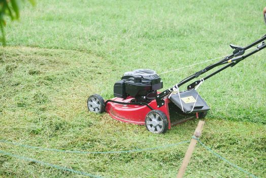 slow motion of Lawn mower on grass in garden,