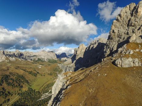 Aerial of the Dolomites, Sella Mountain and Cir in the Background, Passo Gardena, Grödnerjoch in between the Mountains. Aerial of Spring Landscape in South Tirol