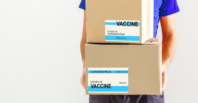 the man delivers the vaccine. Placing VACCINE label on the cardboard box