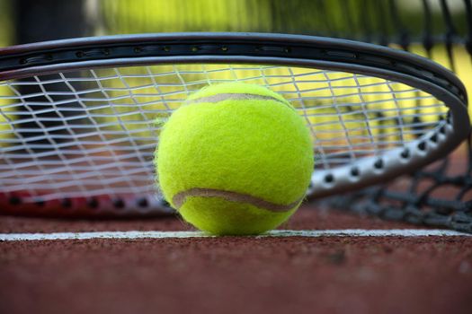 Tennis rocket over tennis ball in low angle view