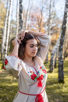 beautiful woman in ukrainian national traditional costume clothes in forest
