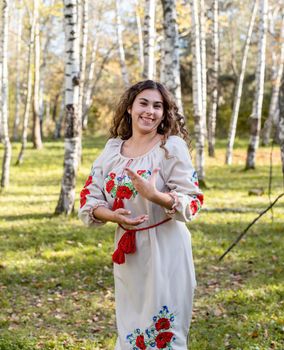 beautiful woman in ukrainian national traditional costume clothes dancing in forest