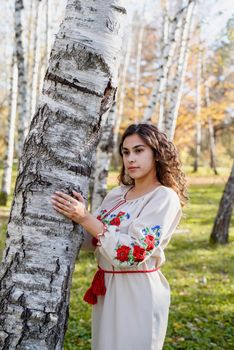 beautiful woman in ukrainian national traditional costume clothes in forest