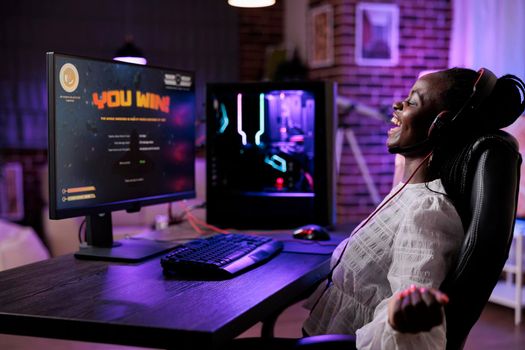 Female player celebrating successful video games online win