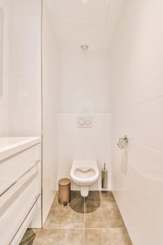 Narrow toilet room with minimalist design