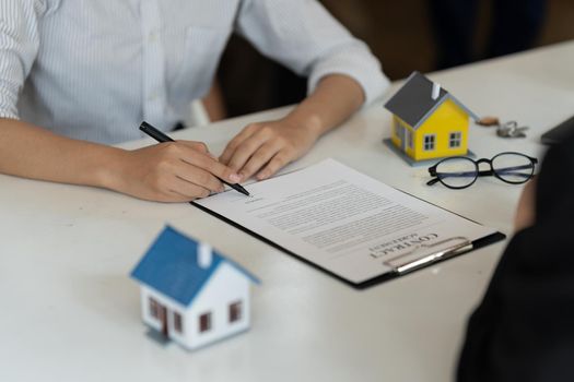 Businessman and estate agent signing a document for house deal