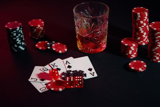 Cards of poker player. On the table are chips and a glass of cocktail with whiskey. Combination of cards - Royal Flush
