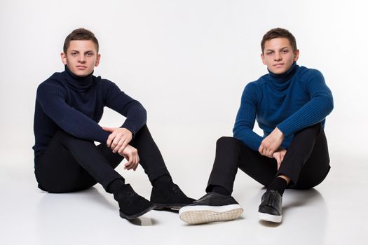Casual twin brothers. Studio shoton a white background