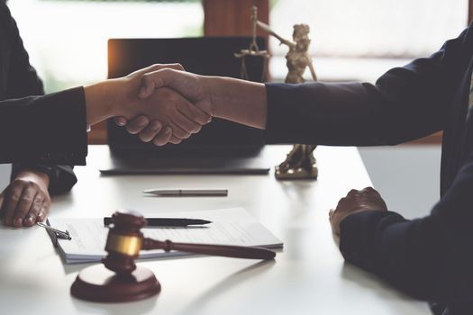 Business woman and lawyer shaking hand after discussing about agreement contract. Law, legal services, advice, Justice concept.