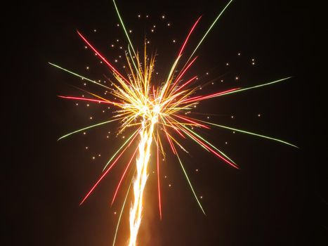 Exploding fireworks against black night sky