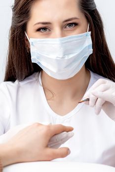 Portrait of manicure master with protective mask