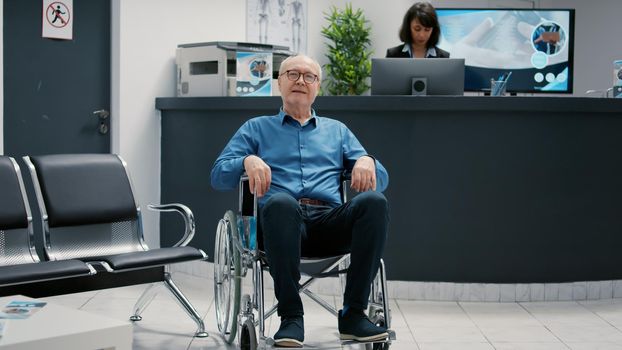 Portrait of retired patient with physical disability in waiting room