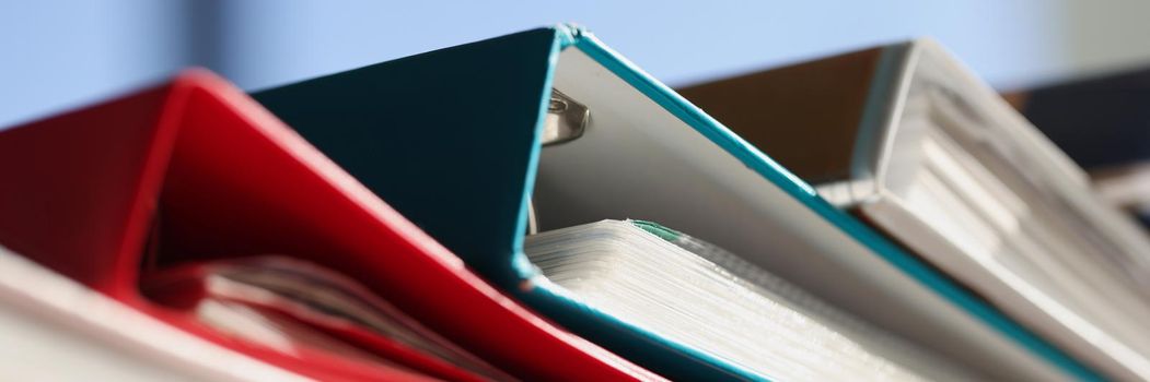 Stack of colourful folders for documents on table