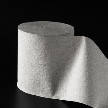 Roll of toilet paper on black background isolated