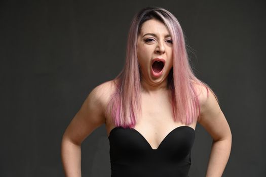 Woman with dyed hair really yawns at the camera