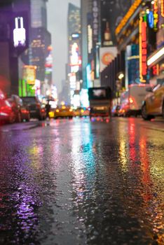 Times Square in NYC by night with rain