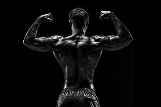 Strong Athletic Man Fitness Model posing back muscles, triceps o