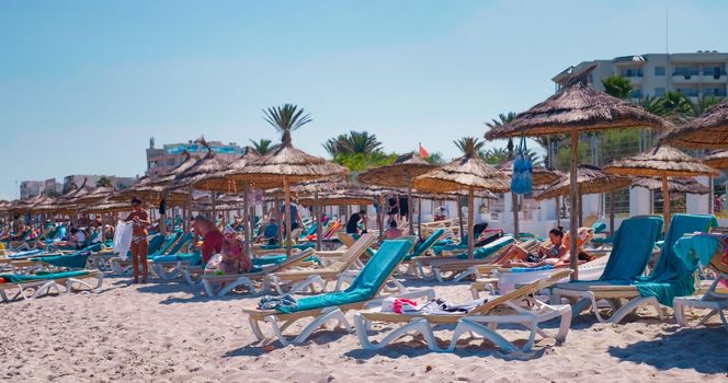 People relax on Mediterranean Sea beach