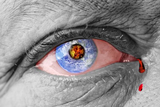 The earth globe inside of a man's eye. the concept of the destruction of the earth in the human eye