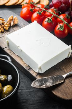 Traditional greek feta cheese, on black wooden table