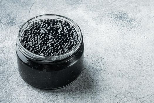 Black sturgeon caviar, on gray background with copy space for text
