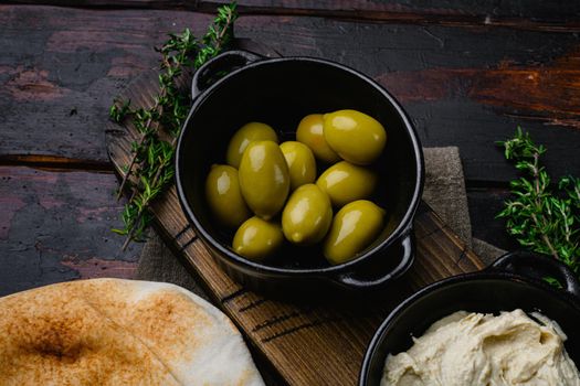 Lebanese bread, pita bread and olives set, on old dark wooden table background, with copy space for text