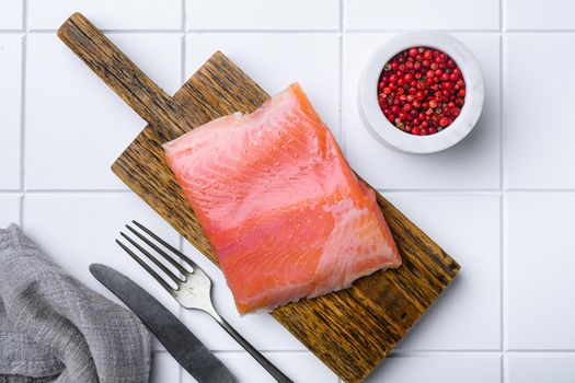 Fresh salmon fillet cut set, on white ceramic squared tile table background, top view flat lay